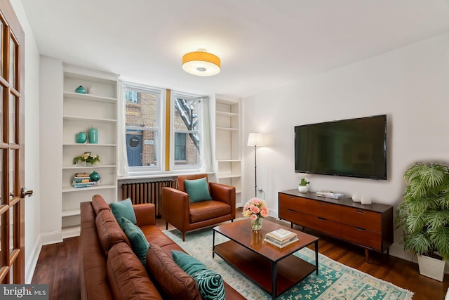 living room with radiator heating unit and dark hardwood / wood-style floors