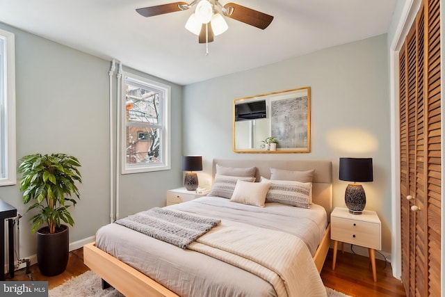 bedroom featuring ceiling fan, wood-type flooring, and a closet