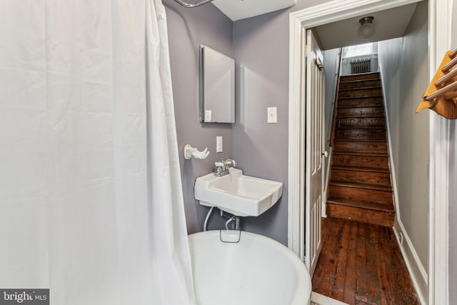 stairs with sink and hardwood / wood-style floors