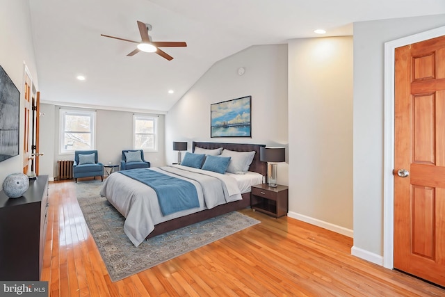 bedroom featuring vaulted ceiling, radiator, ceiling fan, and light hardwood / wood-style flooring