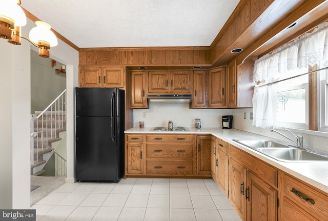 kitchen featuring extractor fan, white electric stovetop, ornamental molding, sink, and black fridge