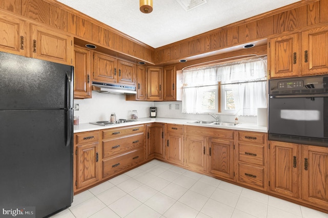 kitchen featuring crown molding, sink, black appliances, and a textured ceiling