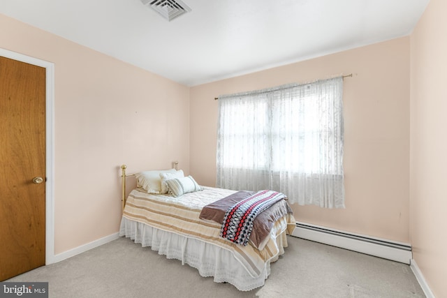 carpeted bedroom featuring baseboard heating