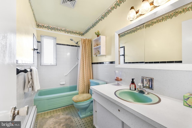 full bathroom with a baseboard radiator, toilet, shower / bath combo with shower curtain, tile walls, and vanity