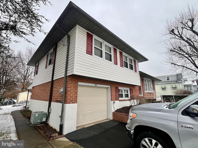 view of home's exterior with ac unit and a garage