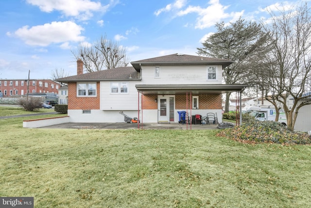 back of property with a patio and a lawn