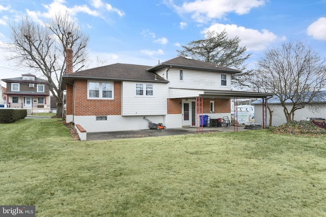 back of house with a lawn and a patio