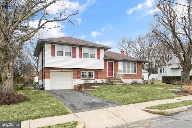 tri-level home featuring central AC, a front yard, and a garage