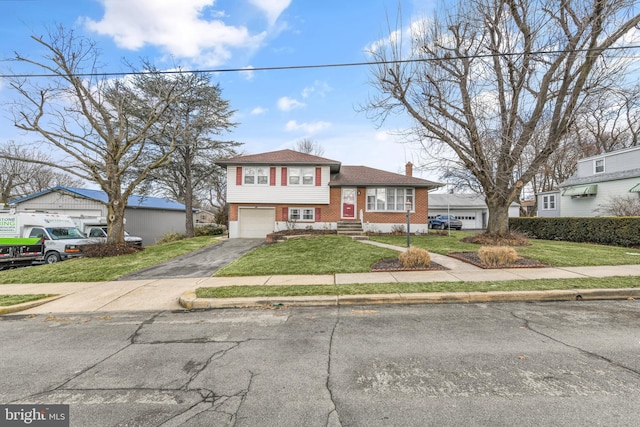 view of front of home with a garage and a front yard