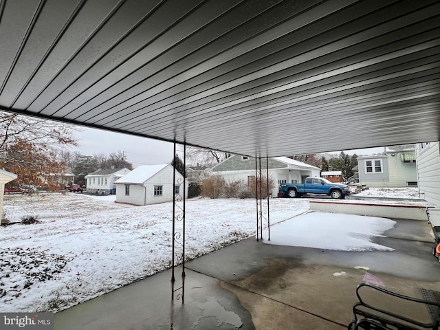 snow covered patio featuring an outbuilding