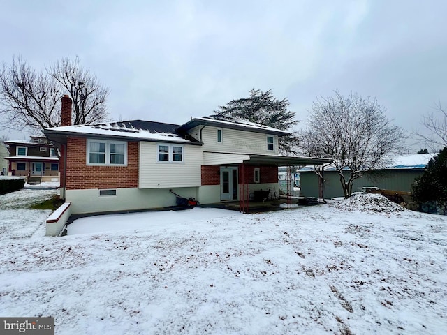 view of snow covered house