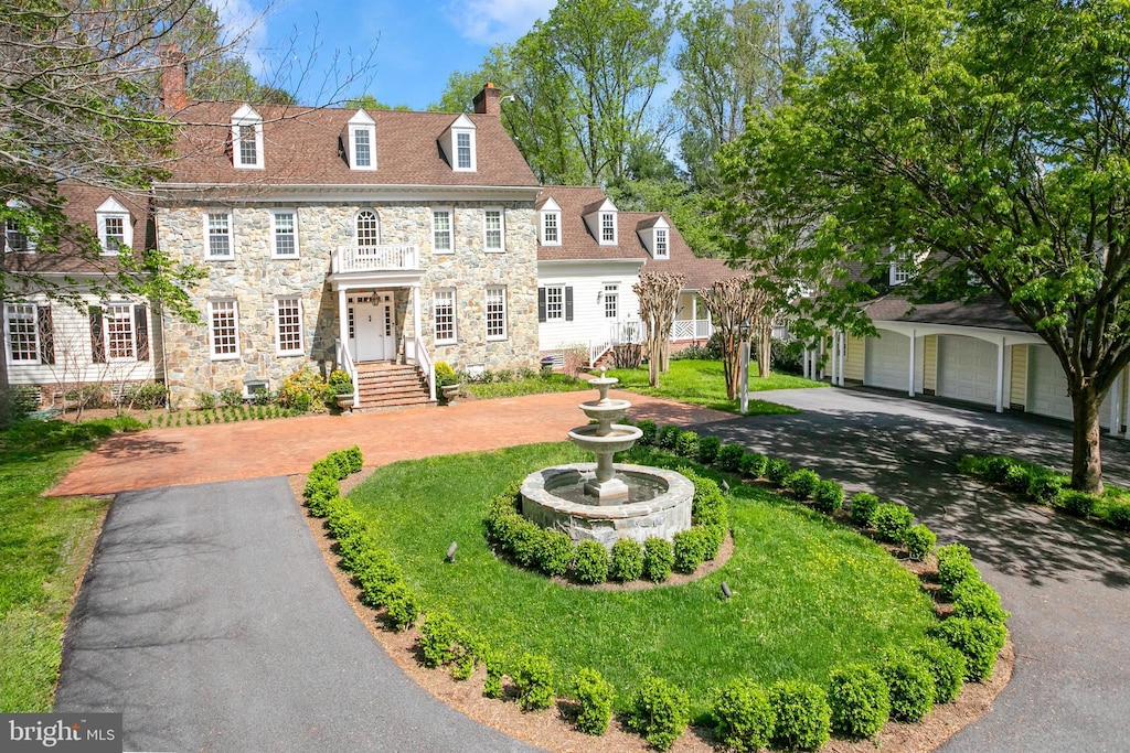 view of front of property featuring a garage and an outbuilding