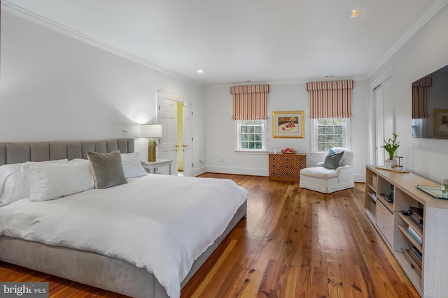 bedroom with hardwood / wood-style flooring and ornamental molding