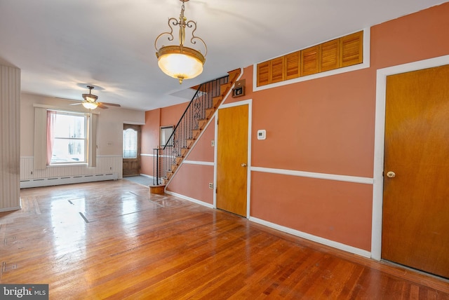 interior space featuring a baseboard radiator, hardwood / wood-style floors, and ceiling fan