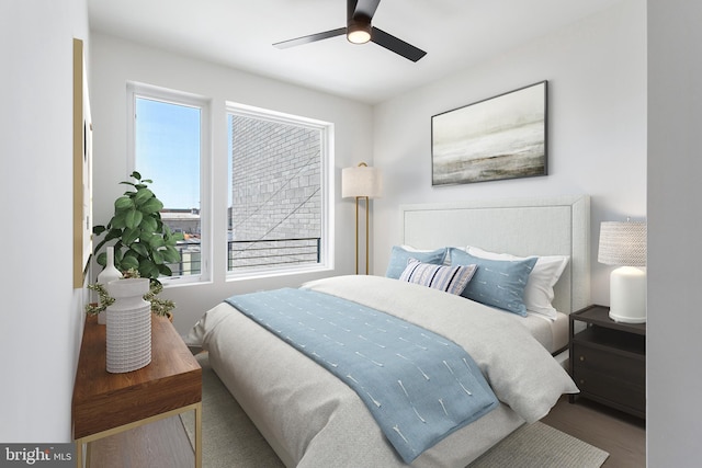 bedroom featuring hardwood / wood-style flooring, ceiling fan, and multiple windows