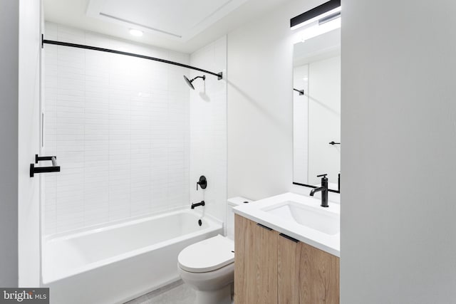 full bathroom featuring vanity, tiled shower / bath combo, and toilet