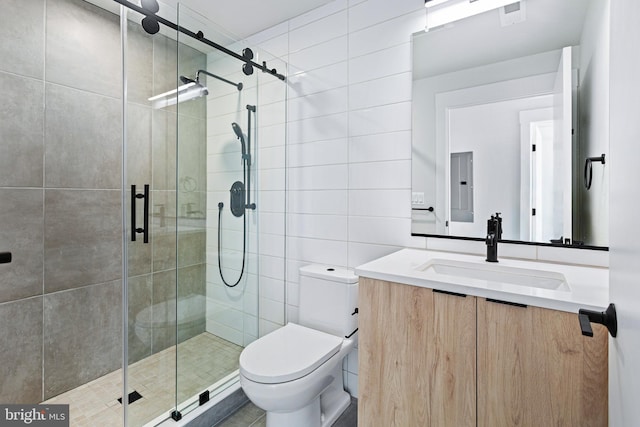 bathroom with vanity, toilet, electric panel, and a shower with shower door