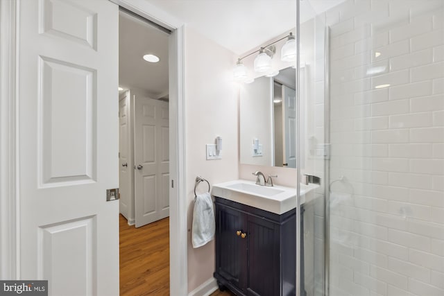 bathroom featuring vanity, a shower with door, and hardwood / wood-style floors