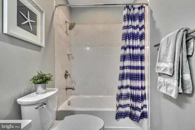 bathroom with toilet and shower / bath combo with shower curtain