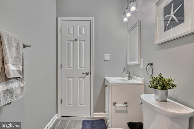 bathroom featuring vanity and toilet