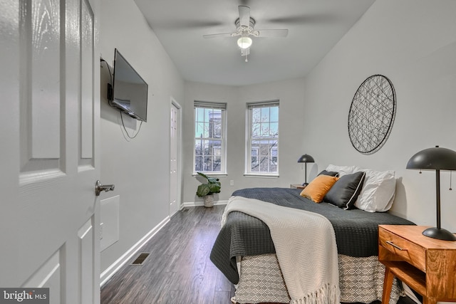 bedroom featuring dark hardwood / wood-style flooring and ceiling fan