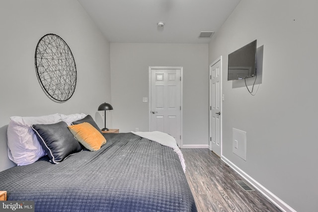 bedroom with hardwood / wood-style flooring