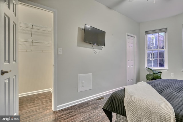 bedroom with dark hardwood / wood-style floors