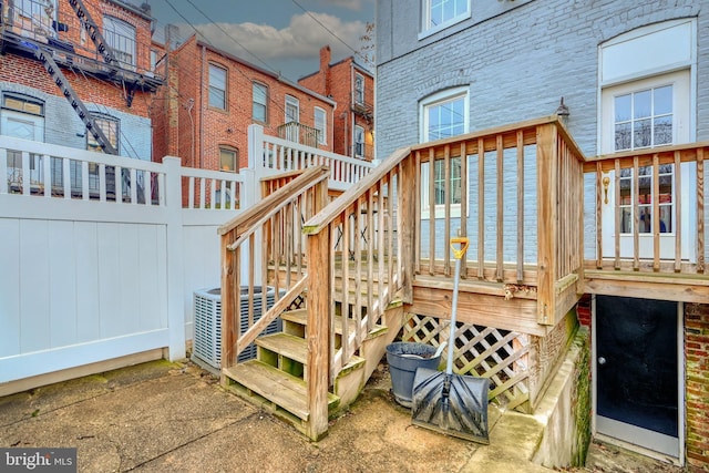 wooden deck featuring cooling unit