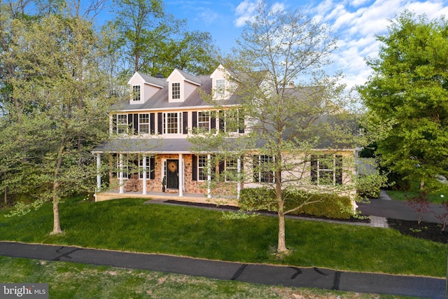 view of front of property featuring stone siding and a front lawn