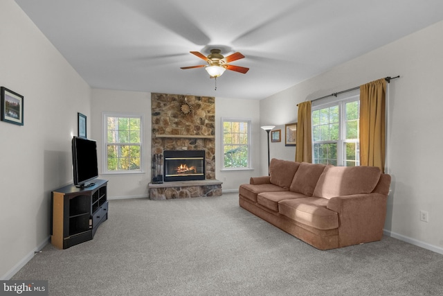 living area with ceiling fan, carpet, and a wealth of natural light