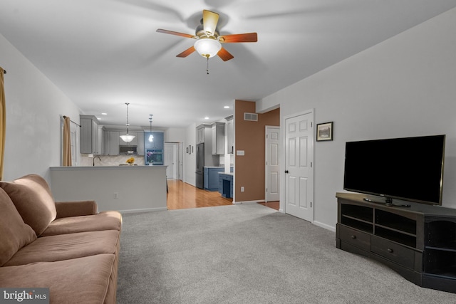 living room with visible vents, baseboards, ceiling fan, light colored carpet, and recessed lighting
