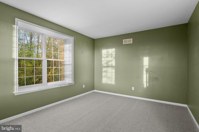 spare room featuring visible vents, baseboards, and a healthy amount of sunlight