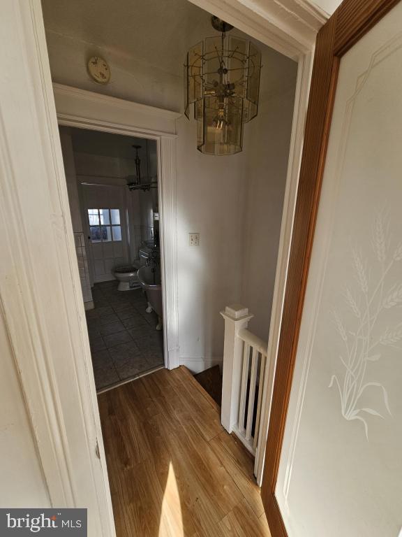 hallway with hardwood / wood-style floors