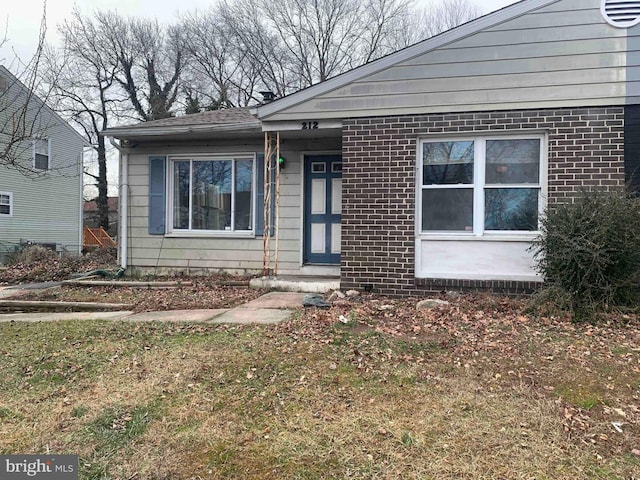 bungalow-style home with a front yard