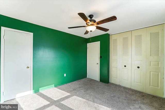 unfurnished bedroom with carpet floors, a closet, and ceiling fan