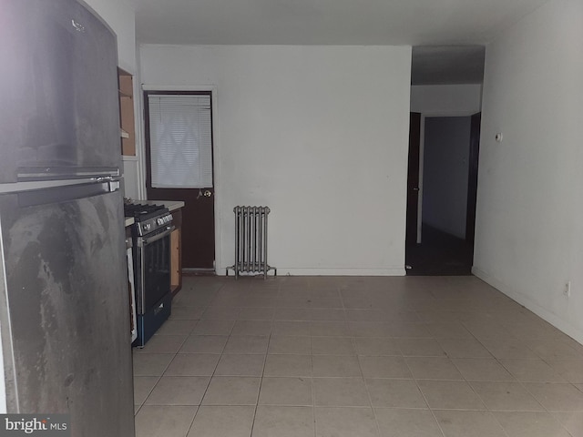 kitchen with light tile patterned floors and appliances with stainless steel finishes