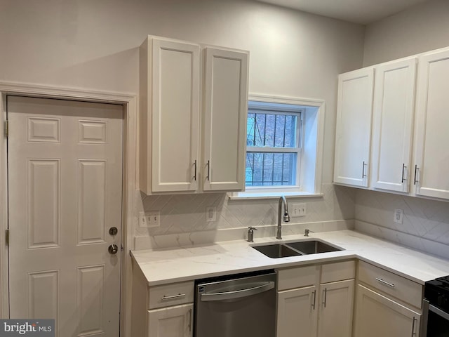 kitchen with tasteful backsplash, dishwasher, sink, and white cabinets