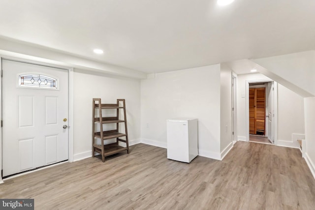 entrance foyer featuring light wood-type flooring, baseboards, and recessed lighting