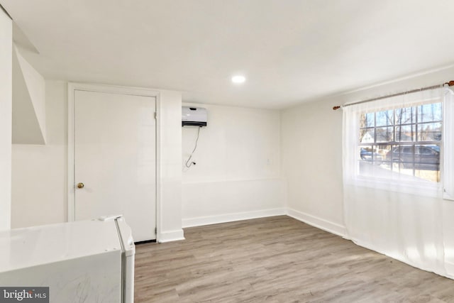 interior space with baseboards, recessed lighting, and light wood-style floors