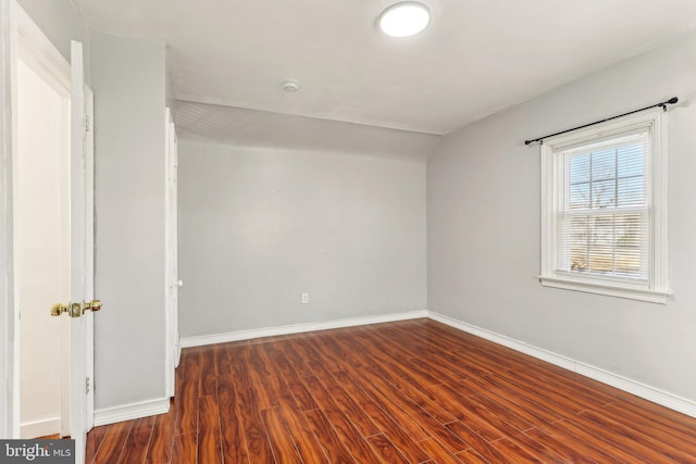 unfurnished room with wood finished floors and baseboards