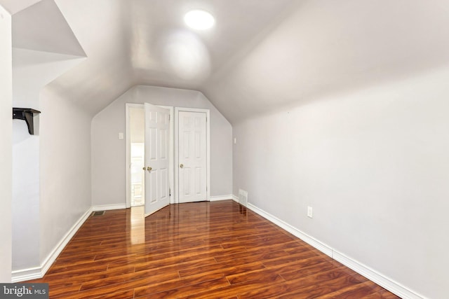 bonus room with lofted ceiling, wood finished floors, and baseboards