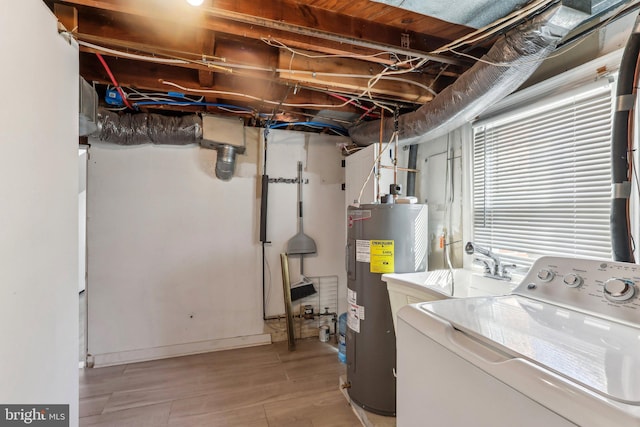 laundry room featuring washer / clothes dryer, water heater, light wood-style flooring, a sink, and laundry area