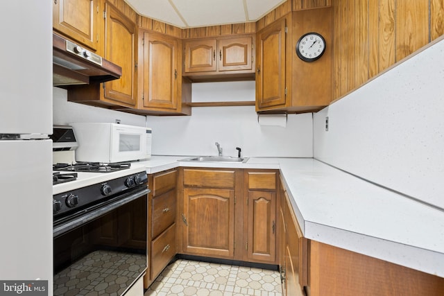 kitchen featuring white appliances and sink