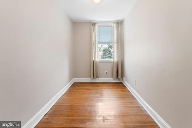 empty room with hardwood / wood-style flooring