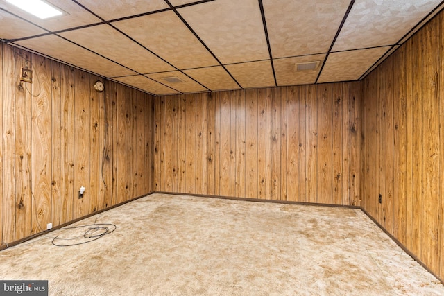 basement featuring wooden walls and carpet floors