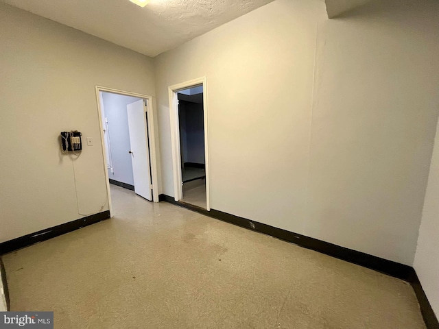 spare room with a textured ceiling