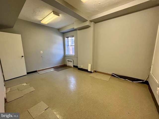 unfurnished room featuring a textured ceiling