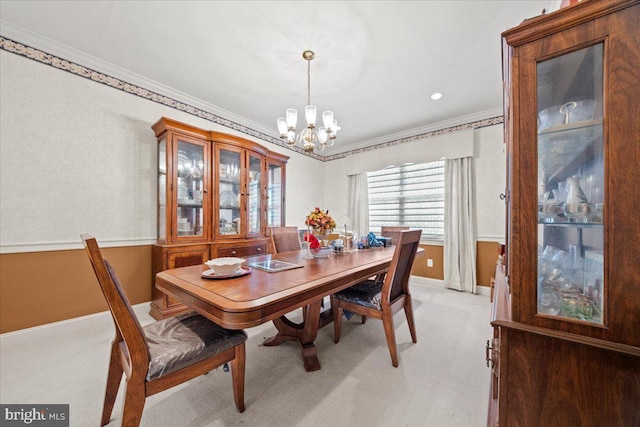 dining space featuring ornamental molding, light carpet, and a notable chandelier