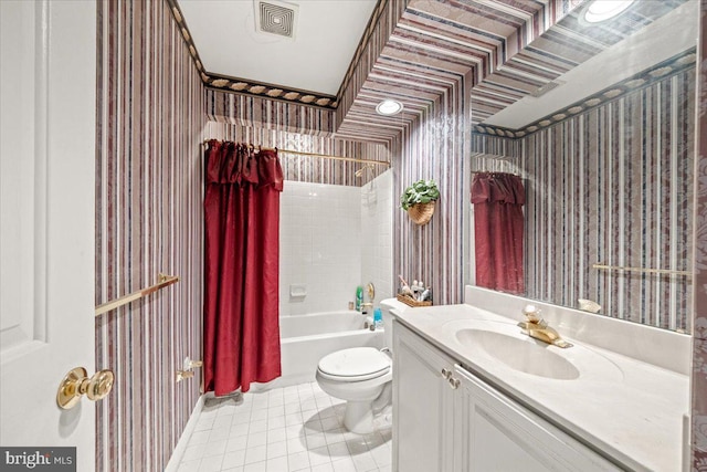 full bathroom with tile patterned floors, shower / bath combo with shower curtain, vanity, and toilet