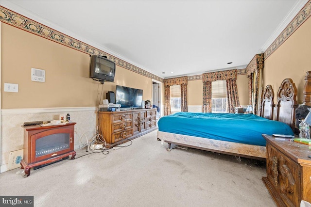 carpeted bedroom with ornamental molding